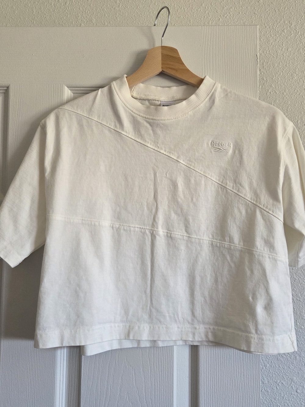 Reebok crop top featuring a distinct diagonal seam across the chest